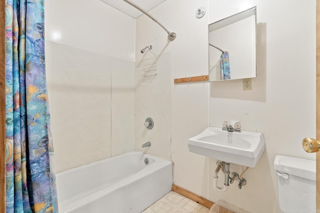 bathroom featuring shower / bath combo, a sink, toilet, and tile patterned floors