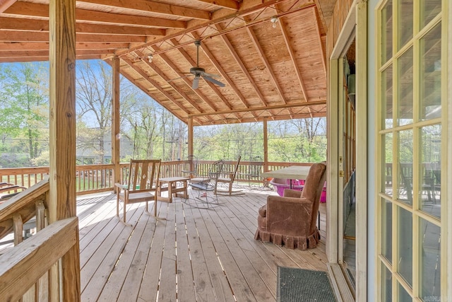 sunroom / solarium with vaulted ceiling and a ceiling fan