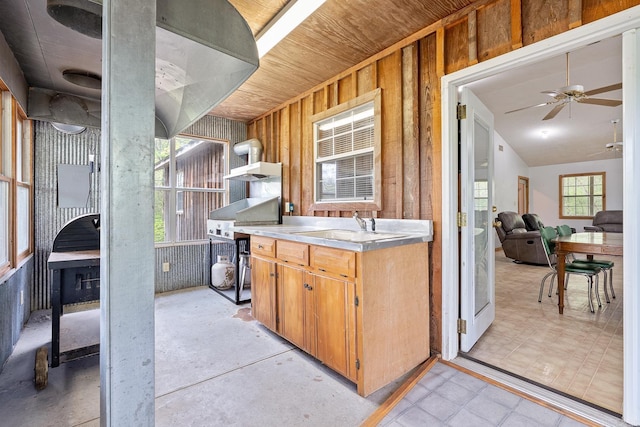 kitchen featuring open shelves, lofted ceiling, light countertops, a sink, and ceiling fan