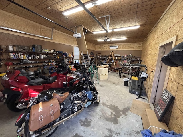 garage featuring a garage door opener and a workshop area