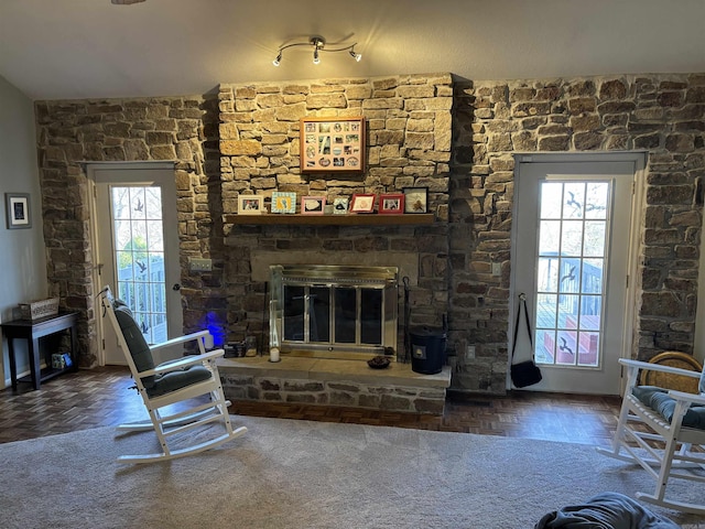 living area with a stone fireplace