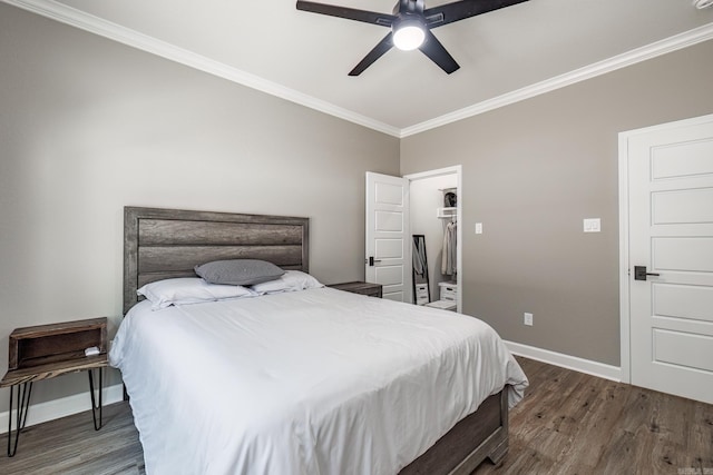 bedroom featuring ornamental molding, a ceiling fan, baseboards, and wood finished floors