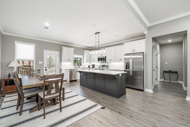 kitchen featuring stainless steel appliances, light countertops, visible vents, and white cabinets