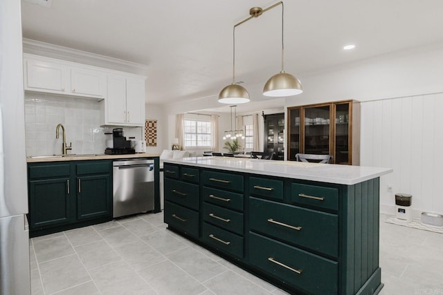 kitchen featuring light countertops, stainless steel dishwasher, white cabinetry, green cabinets, and a sink