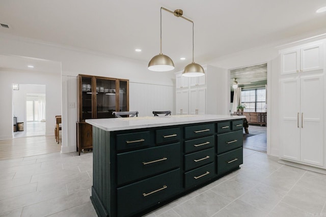 kitchen with pendant lighting, light countertops, visible vents, light tile patterned flooring, and a kitchen island