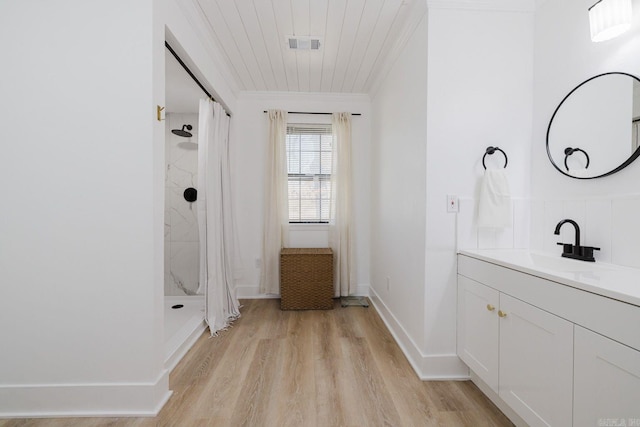 bathroom with crown molding, curtained shower, visible vents, vanity, and wood finished floors