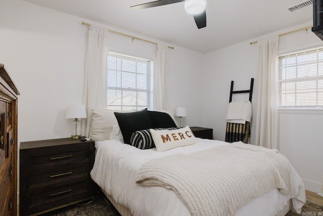 bedroom with ceiling fan and visible vents