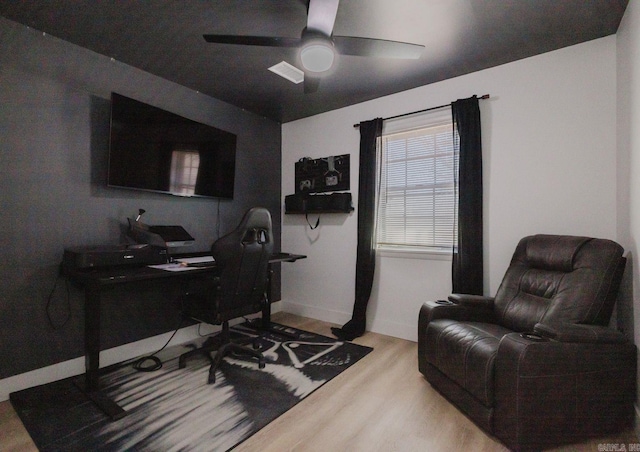 office with wood finished floors, a ceiling fan, and baseboards