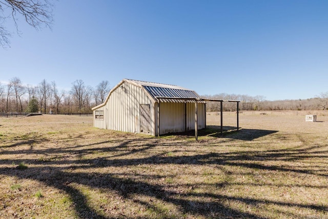 view of outbuilding featuring a rural view and an outbuilding