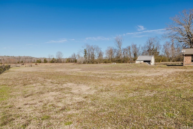 view of yard featuring an outbuilding and a rural view