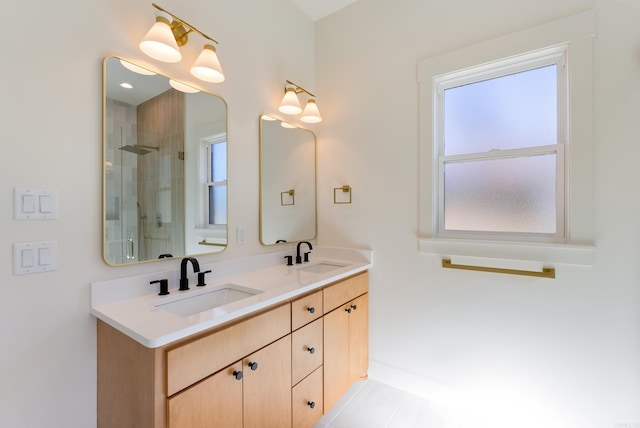 full bath with a sink, a shower stall, and double vanity