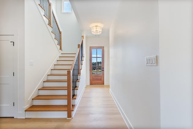 stairway with baseboards and wood finished floors