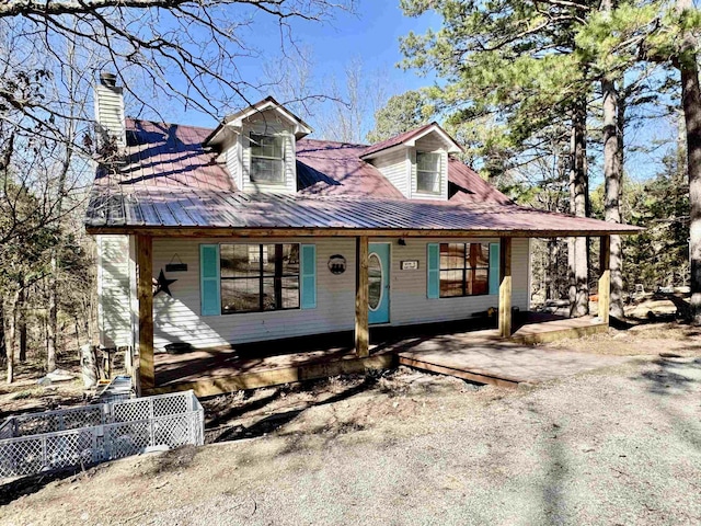 view of front of home with a porch and fence
