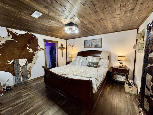 bedroom with wood ceiling, visible vents, a walk in closet, and wood finished floors