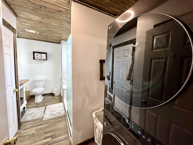 full bathroom with toilet, stacked washer and dryer, wood finished floors, and wood ceiling