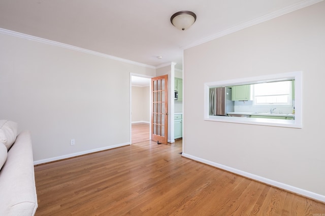 spare room with light wood finished floors and baseboards