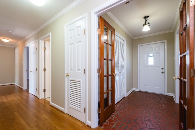 hall with crown molding, baseboards, and wood finished floors