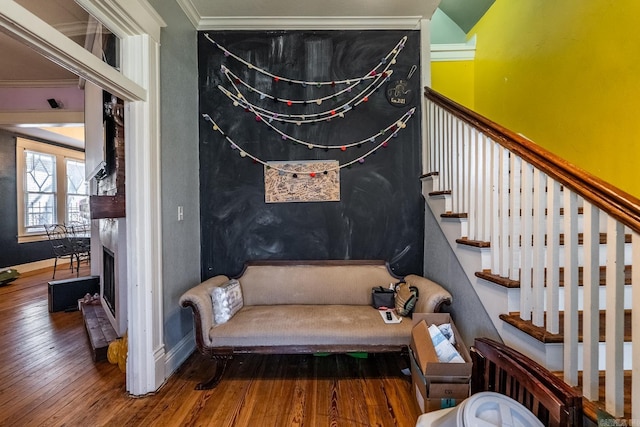 stairs featuring ornamental molding, hardwood / wood-style flooring, and baseboards