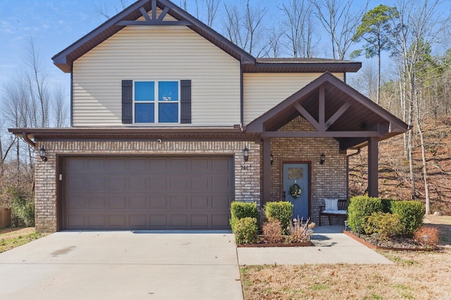 view of front of home featuring concrete driveway, brick siding, and an attached garage