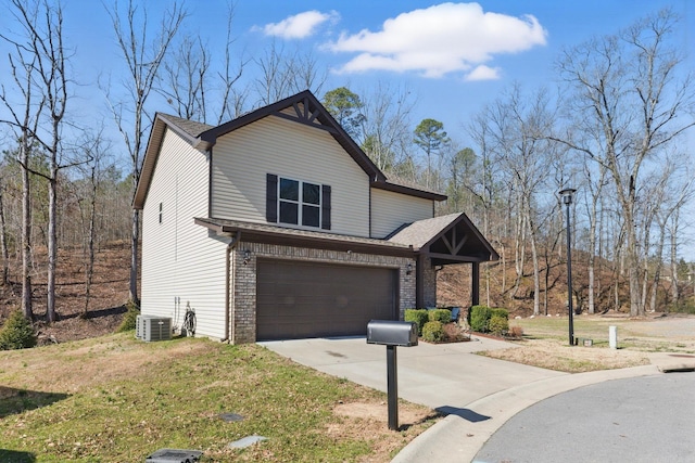 view of front of home featuring a garage, driveway, brick siding, and central air condition unit