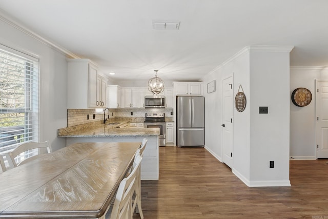 kitchen featuring dark wood-style flooring, visible vents, ornamental molding, appliances with stainless steel finishes, and backsplash