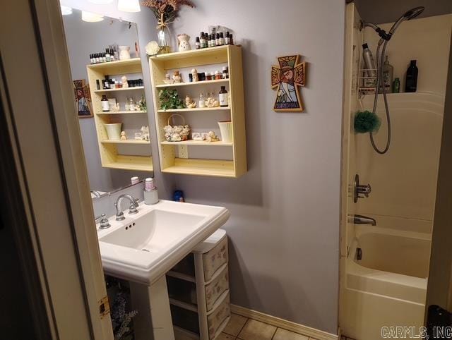 full bath with baseboards,  shower combination, a sink, and tile patterned floors