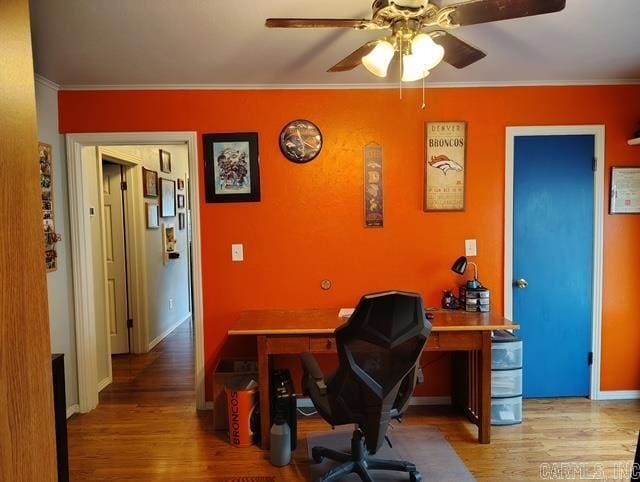 home office with ceiling fan, ornamental molding, wood finished floors, and baseboards