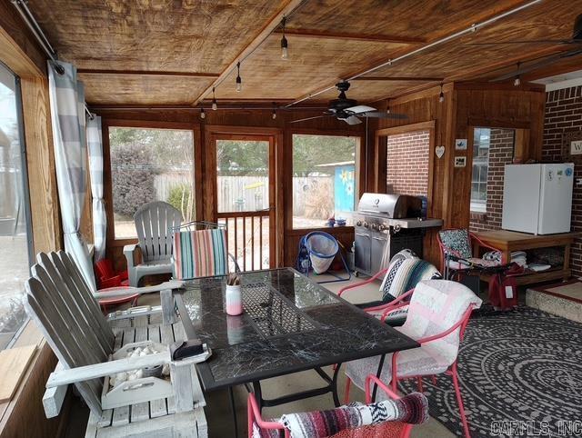 sunroom featuring wooden ceiling and ceiling fan