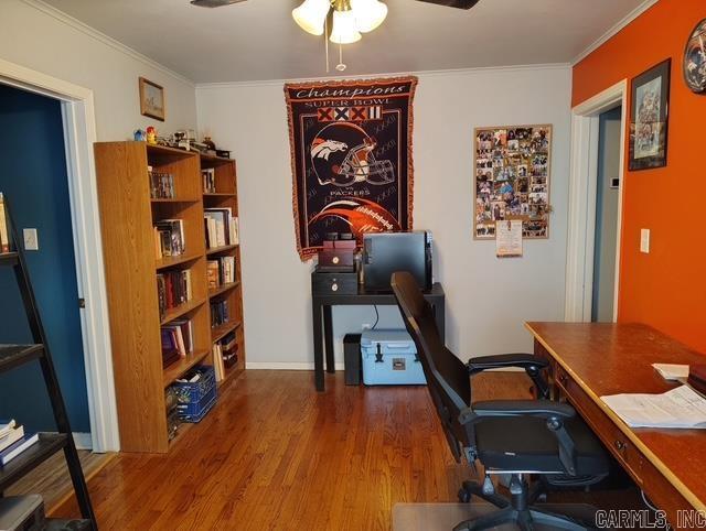 office area featuring ceiling fan, wood finished floors, and crown molding