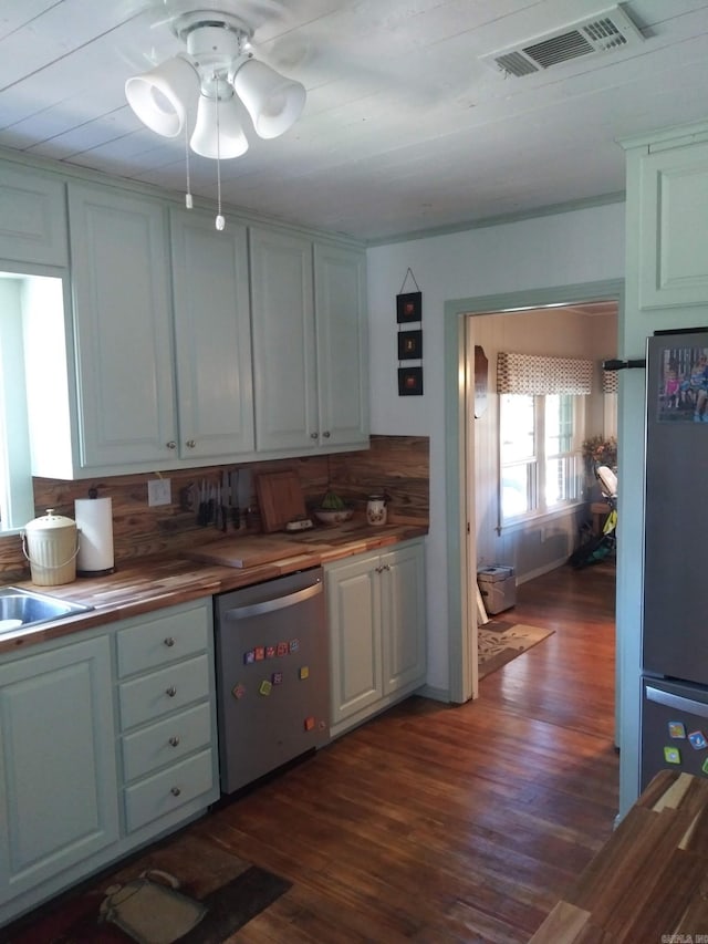 kitchen with visible vents, butcher block countertops, dark wood-type flooring, freestanding refrigerator, and stainless steel dishwasher