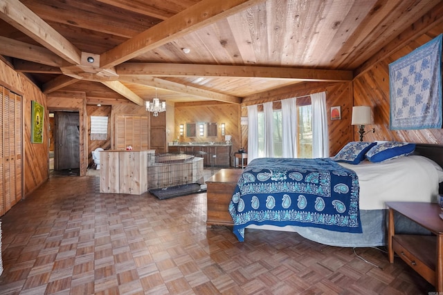 bedroom featuring beam ceiling, a notable chandelier, wood walls, and wooden ceiling