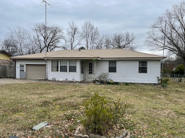 ranch-style home with a front yard, metal roof, fence, a garage, and driveway