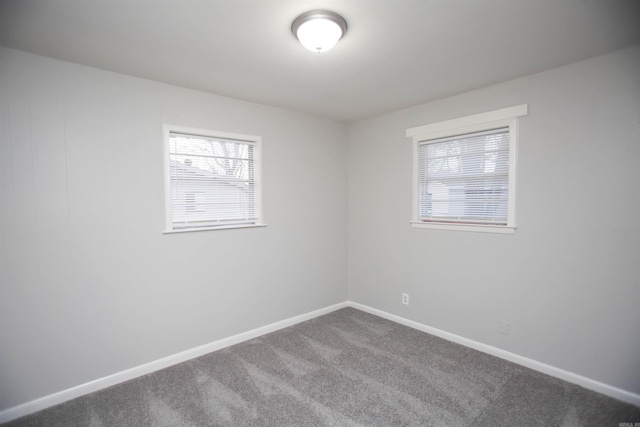 spare room with carpet and baseboards