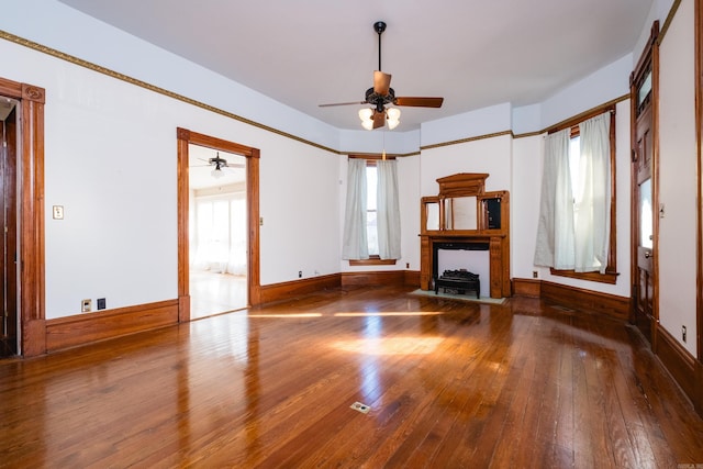 unfurnished living room featuring a fireplace with flush hearth, wood-type flooring, and plenty of natural light