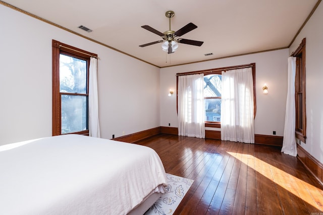 unfurnished bedroom featuring crown molding, baseboards, and hardwood / wood-style floors