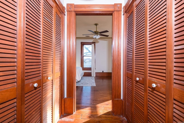 hall with hardwood / wood-style flooring and baseboards