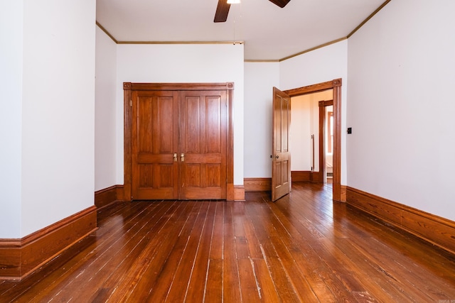 unfurnished bedroom with hardwood / wood-style floors, a ceiling fan, baseboards, and crown molding