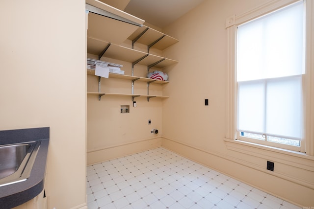 laundry room with washer hookup, hookup for an electric dryer, laundry area, baseboards, and tile patterned floors