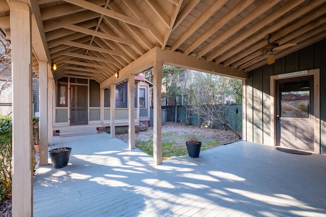 view of patio with a sunroom and fence