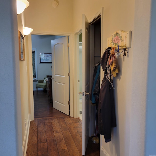 corridor with dark wood-style flooring