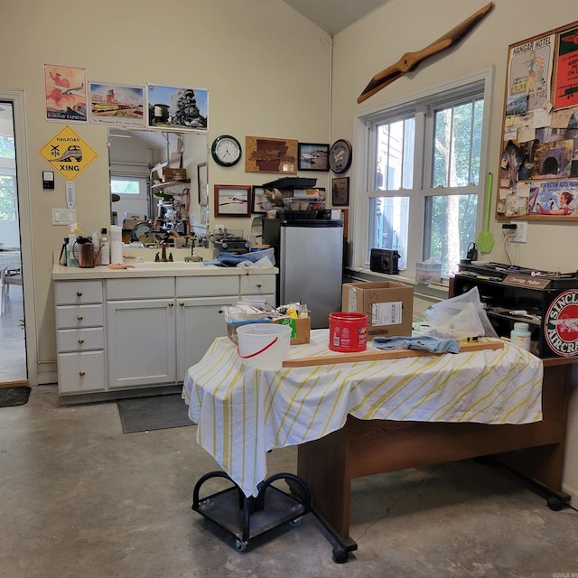 dining space featuring unfinished concrete flooring