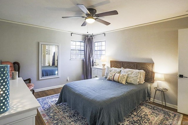 bedroom with crown molding, baseboards, and dark wood-style flooring