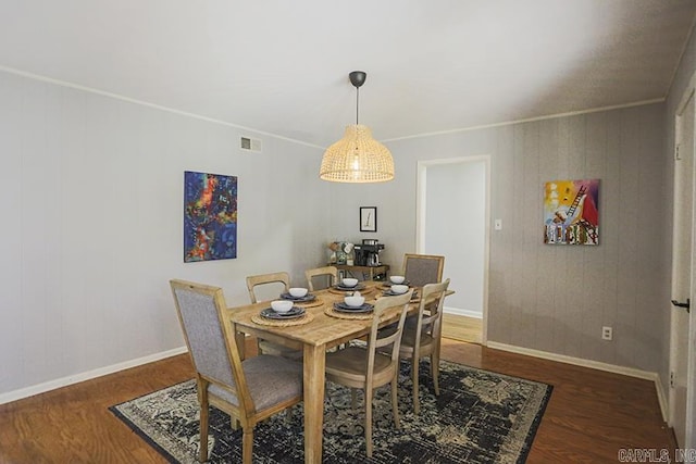 dining area with visible vents, baseboards, and wood finished floors