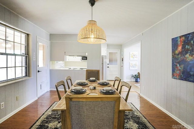 dining area featuring baseboards and wood finished floors