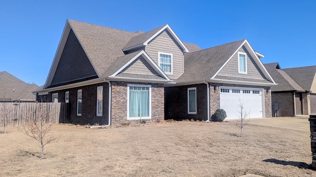 view of front of home with concrete driveway, brick siding, roof with shingles, and fence