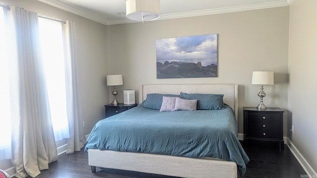 bedroom with crown molding, baseboards, and wood finished floors