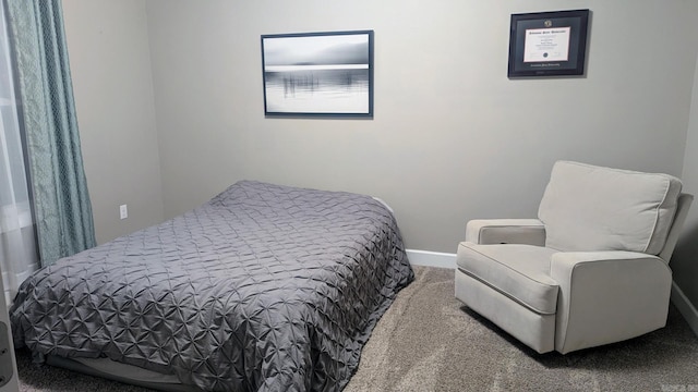 carpeted bedroom featuring baseboards