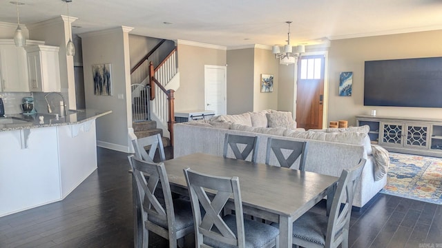 dining area with dark wood-style floors, a notable chandelier, ornamental molding, and stairs