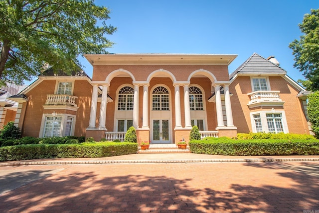 view of front of house with brick siding and french doors