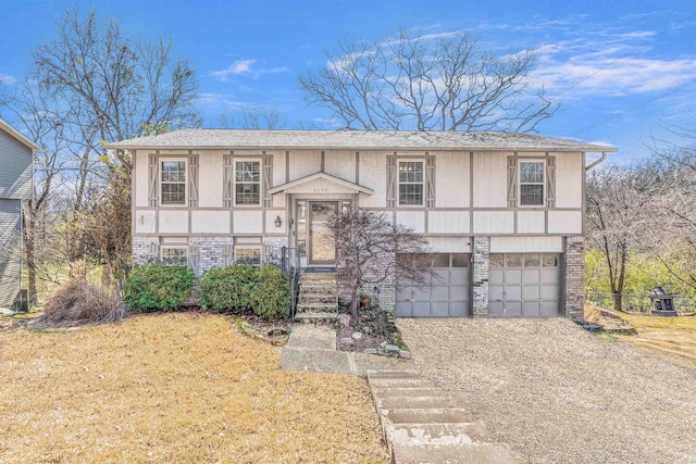 view of front of property featuring driveway, brick siding, an attached garage, and a front yard